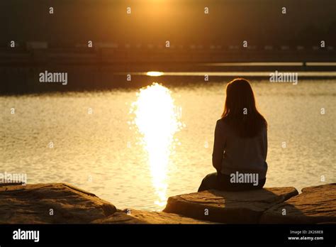 Silhouette Of Woman Watching The Sunset Hi Res Stock Photography And