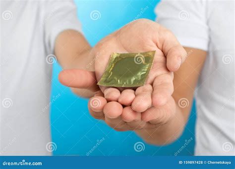 Gay Couple With Condom On Light Blue Background Stock Photo Image Of December Hands 159897428