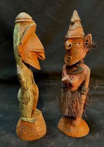 Two Ancestor Figures One Male And One Female Both With Headdresses