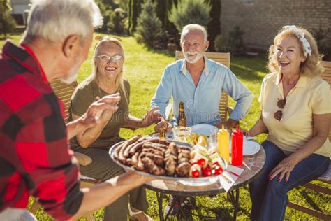 Senior Man Bringing Food On A Tray And Showing Ok Sign While Having