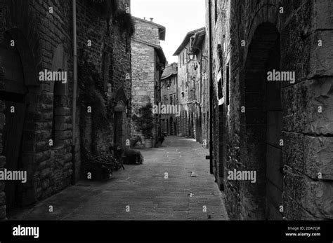 An Alley Of A Medieval Italian Village With Stone Houses Wooden Doors