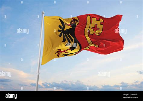 flag of Canton of Geneva , Switzerland at cloudy sky background on ...