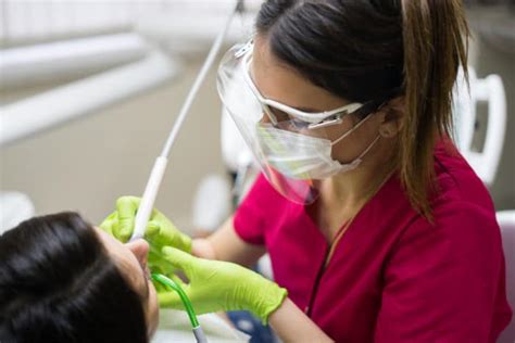 Dental Hygienist Cleaning Teeth