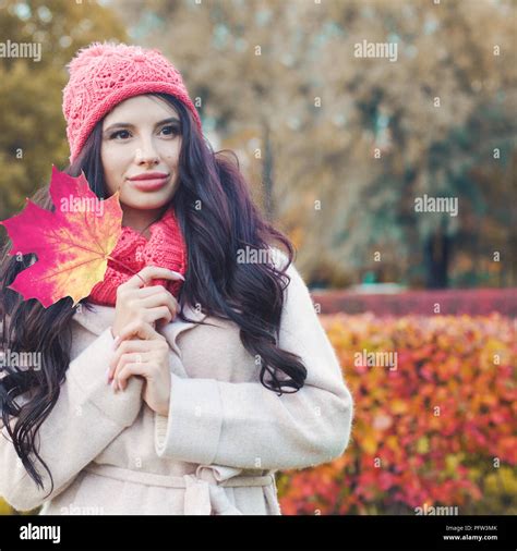 Autumn Portrait Of Perfect Woman With Red Maple Leaf In Fall Park