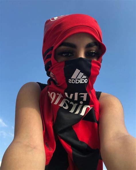 A Woman Wearing A Red And Black Adidas Scarf