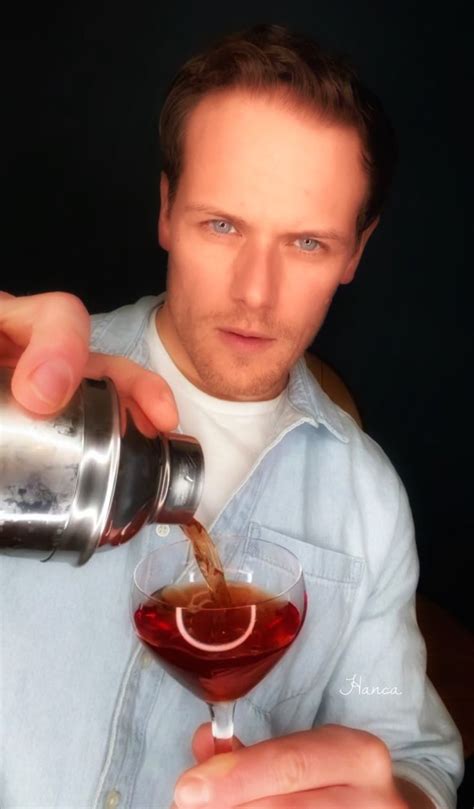 A Man Pouring Something Into A Glass With Liquid In It And Another