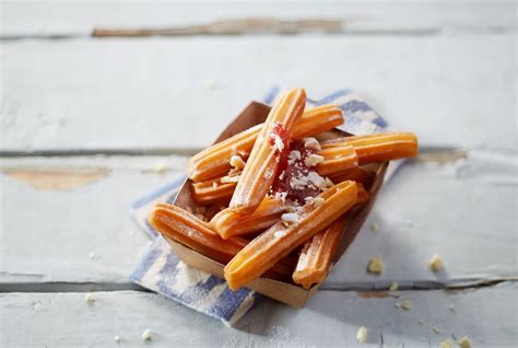 Churros With Strawberry Sauce And White Chocolate Shreds