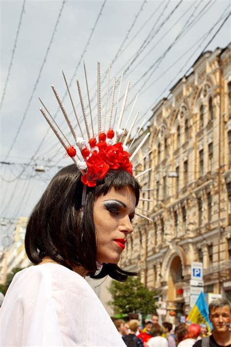 Gender Non Binary Person Is Rolled Up With The Gay Pride Flag On His Body She Is Looking At The