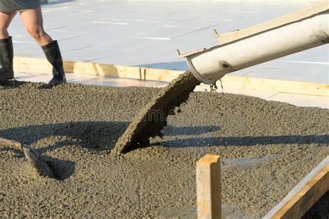 Pouring Concrete From A Concrete Mixer The Work Of People Pouring