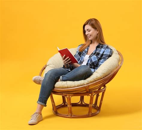 Premium Photo Beautiful Woman Reading Book While Sitting In Armchair