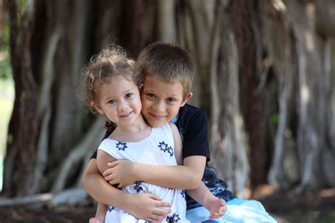 Download Boy Hugging Sister Wallpaper | Wallpapers.com
