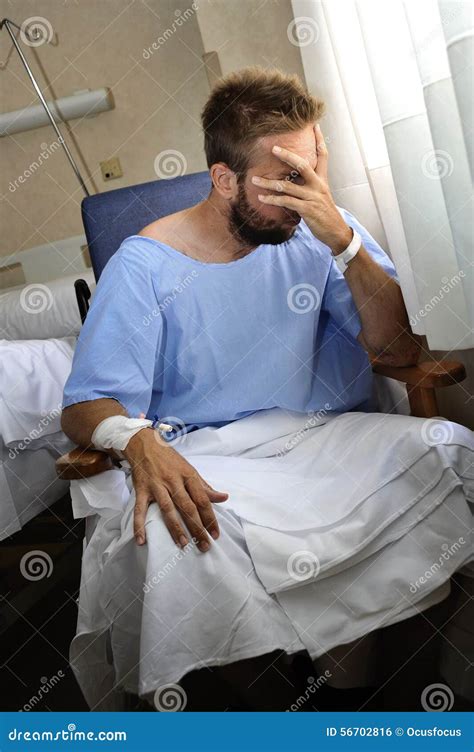 Young injured man crying in hospital room sitting alone crying in pain ...