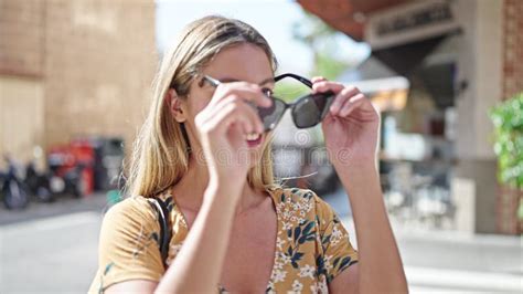 Jeune Femme Blonde Souriante Confiante Portant Des Lunettes De Soleil Dans La Rue Banque De