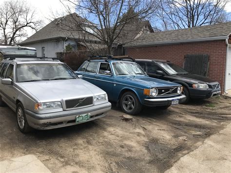 Three Volvos: 1970s, 1990s, and 2000s, all in one backyard