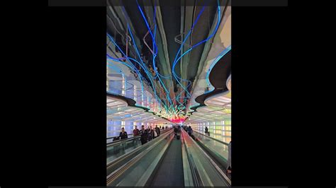 Walking Through The Vibrant Tunnel Connecting Concourses B And C At