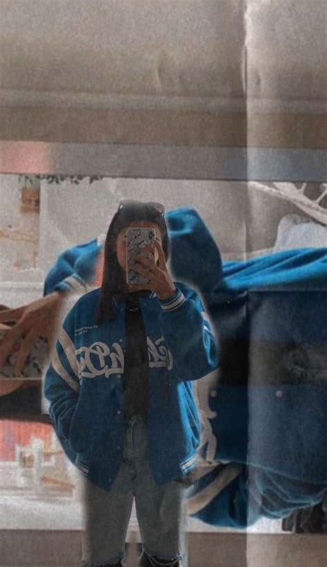 A Person Taking A Selfie In Front Of A Mirror With Their Reflection On It