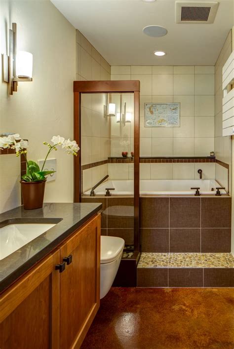 This bathroom features a wall-mounted toilet and vanity, stained ...