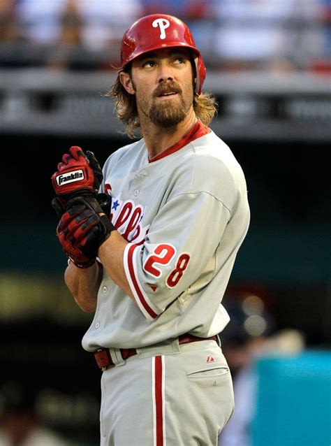 A Baseball Player Standing On The Field With His Hands In His Pockets