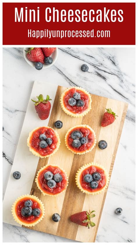 Several Mini Cheesecakes With A Graham Cracker Crust Topped With Strawberry Puree And