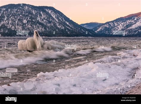 Beautiful winter landscape with a lake, iceberg on the water and ice on ...