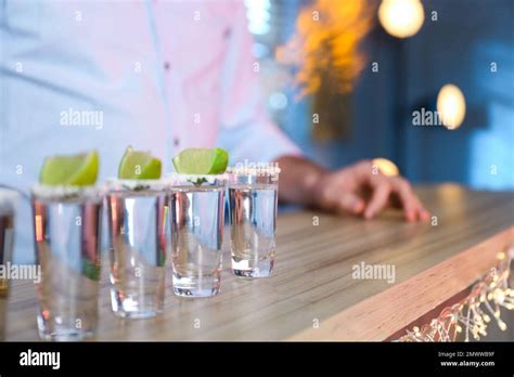 Mexican Tequila Shots With Salt And Lime Slices On Bar Counter Stock