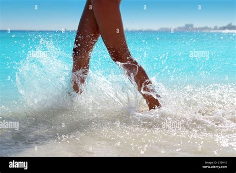 Woman Legs Walking Splashing Beach Water In Caribbean Turquoise Sea