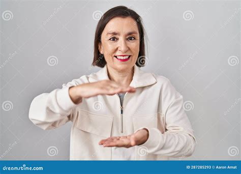 Middle Age Hispanic Woman Standing Over Isolated Background Gesturing