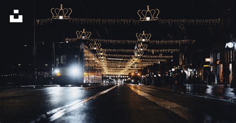 A city street at night with christmas lights photo – Free Town Image on ...