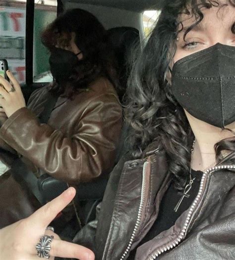 A Woman Wearing A Face Mask While Sitting In A Car