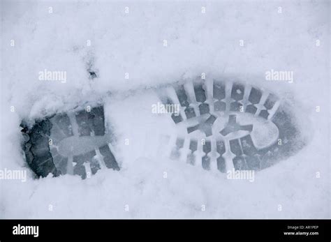 A bootprint in snow Stock Photo - Alamy