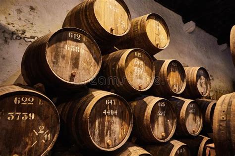 Old Aged Traditional Wooden Barrels With Wine In A Vault Lined Up In