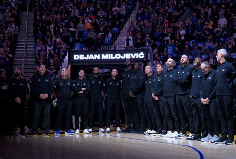 Golden State Warriors coaching staff stand in honor of the late assistant coach Dejan Milojevic ...