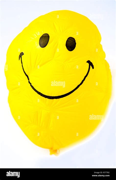 Yellow smiley face balloon hi-res stock photography and images - Alamy