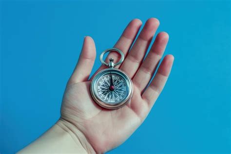 Premium Photo Hand Holding Compass On Blue Background Ai