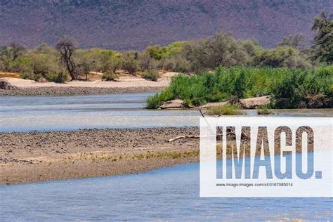 Landscape On The Banks Of The Kunene River The Border River Between