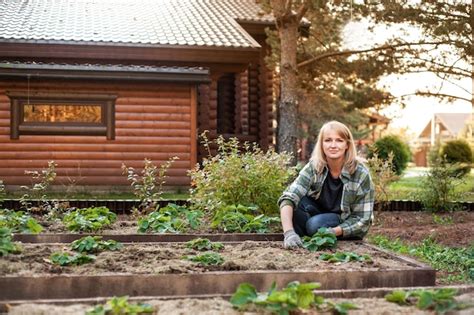 Premium Photo A Beautiful Blonde Woman Works In The Backyard A Woman Processes Strawberry