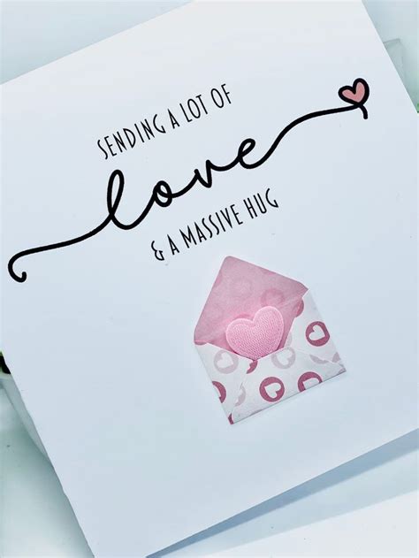 a greeting card with the words sending love and a pink heart on it's ...