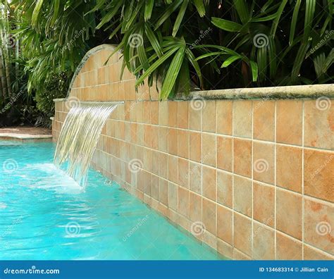 Waterfall Feature in a Beautiful Swimming Pool Stock Photo - Image of ...