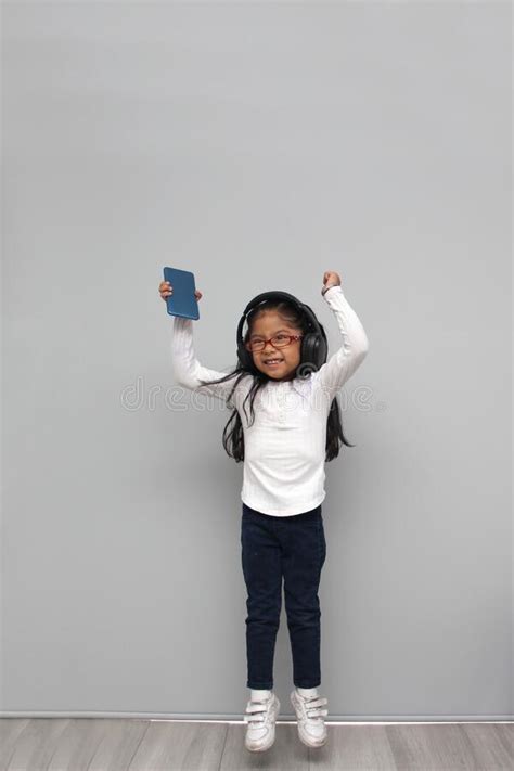 Year Old Brunette Latin Girl With Glasses Listens To Music In Her