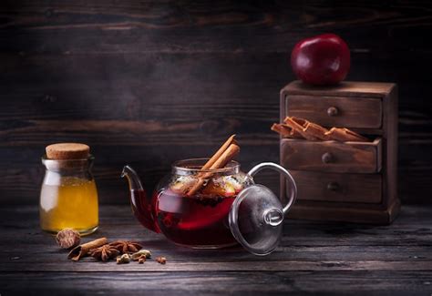 Premium Photo Mulled Wine With Spices And Honey In A Glass Teapot On