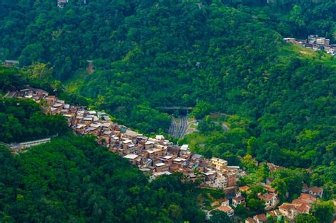 Premium Photo | Aerial view of favelas in rio de janeiro surrounded by ...