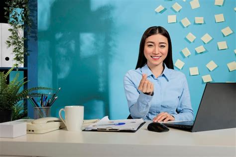 Premium Photo Joyful Female Employee At Workplace Showing Good Mood