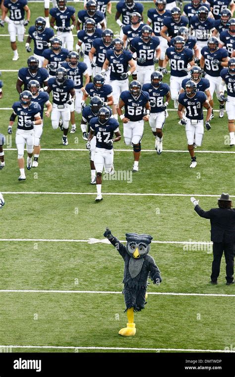 Sammy the Owl, mascot of the Rice Owls, leads the Rice football team ...