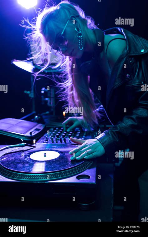 Beautiful Blonde Dj Girl Touching Vinyl Record In Nightclub Stock Photo Alamy