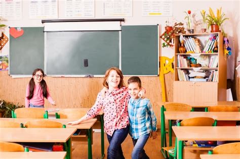 Premium Photo | Two best friends hugging and fun smiling in classroom