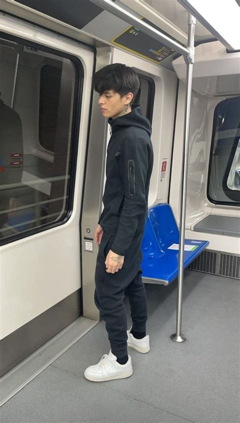 A Person Standing On A Subway Train Looking Out The Window And Waiting