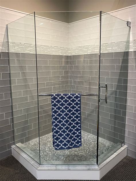 A Glass Shower Door With A Blue Towel On It