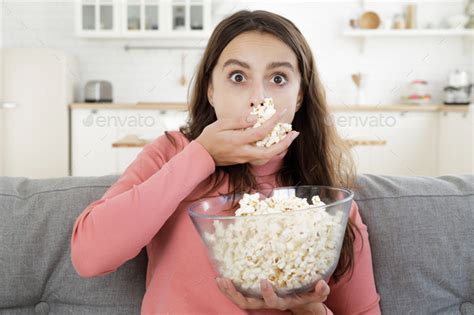 Young Beautiful Woman Eats Popcorn While Watching Tv Completely