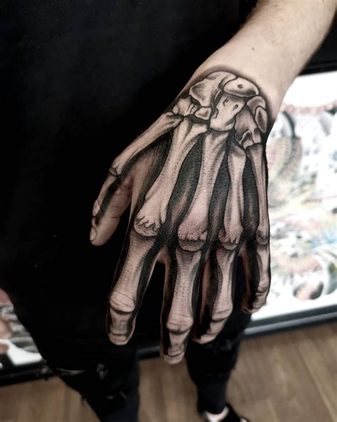 61 Skeleton Hand Tattoo Ideas And Meanings Bone Tattoos Skeleton