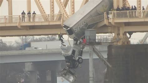 Louisville firefighters rescue driver from truck dangling off bridge